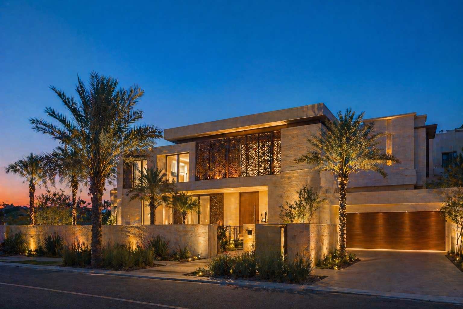 Modern villa at twilight with stone facade and palm trees